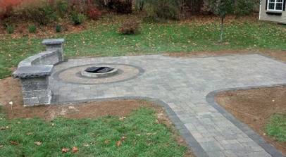 There is a fire pit in the middle of the patio.