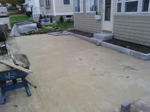 A wheelbarrow is sitting in front of a house.
