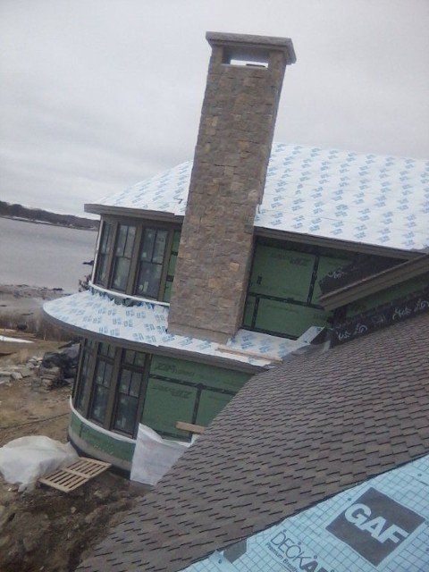 A house under construction with a large chimney on top of it