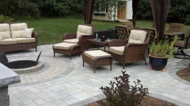 There is a fire pit in the middle of the patio.