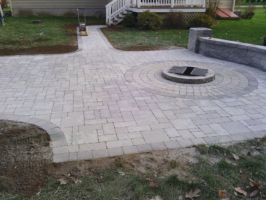 There is a fire pit in the middle of the patio.