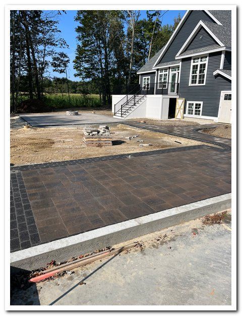 A large house with a concrete driveway in front of it.