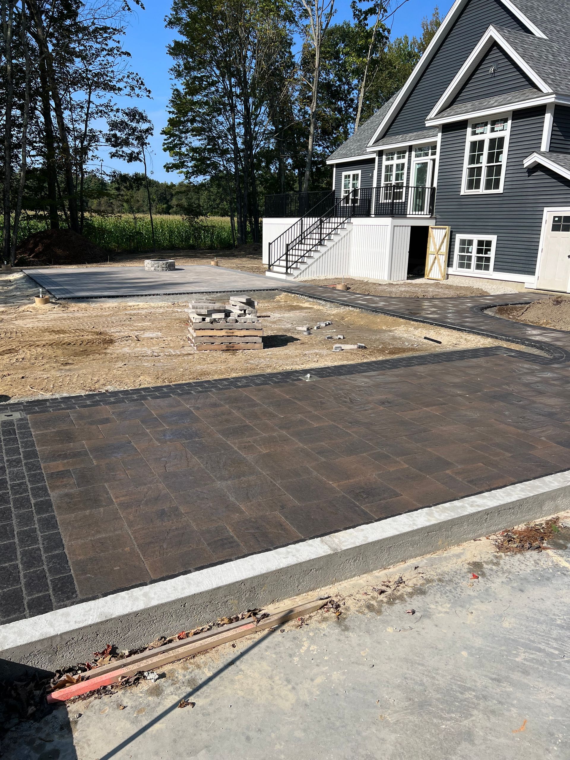 A brick wall is being built in front of a house.