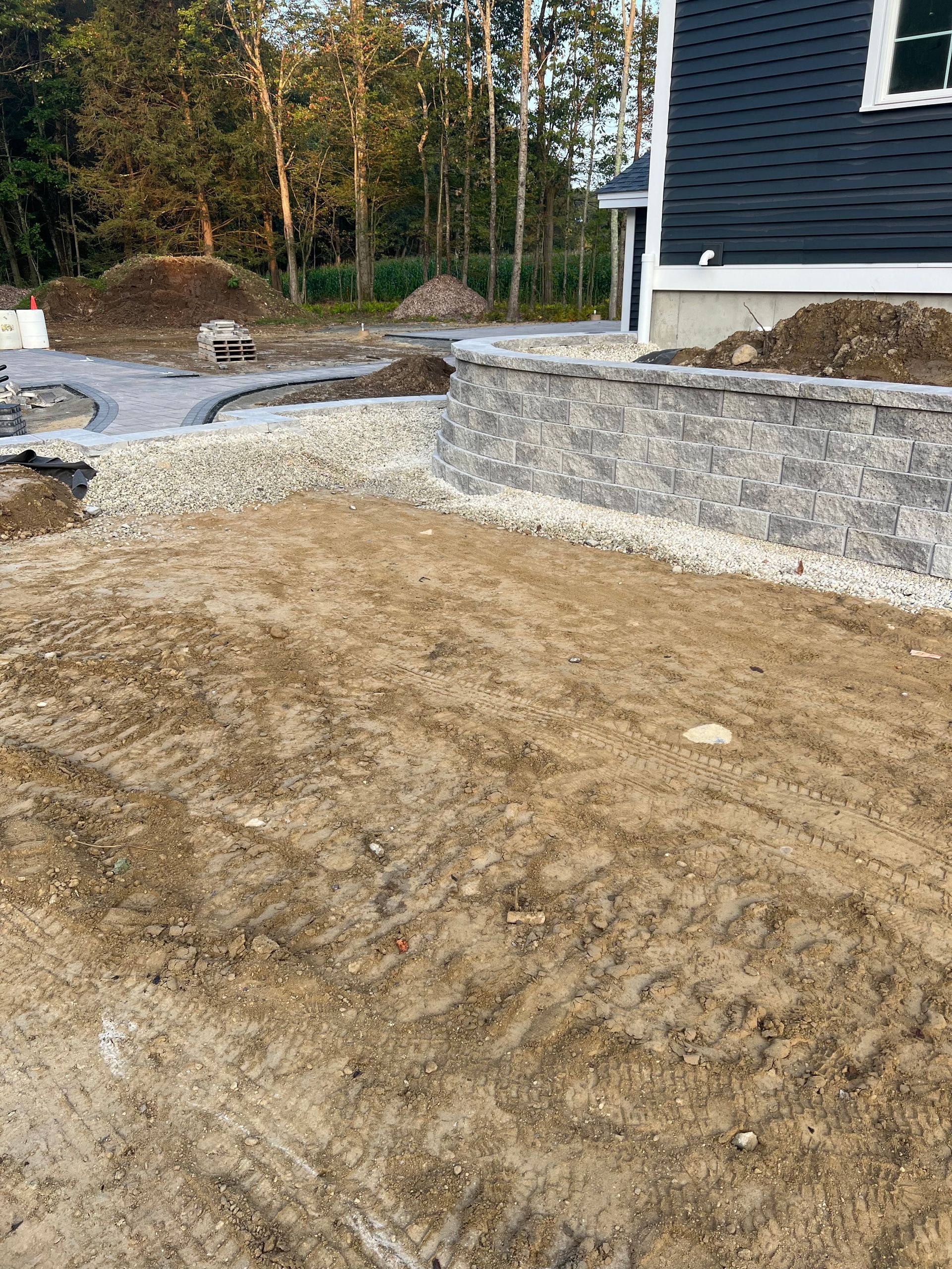 A brick wall is being built in front of a house.