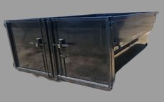 A black metal box with two doors on a gray background.