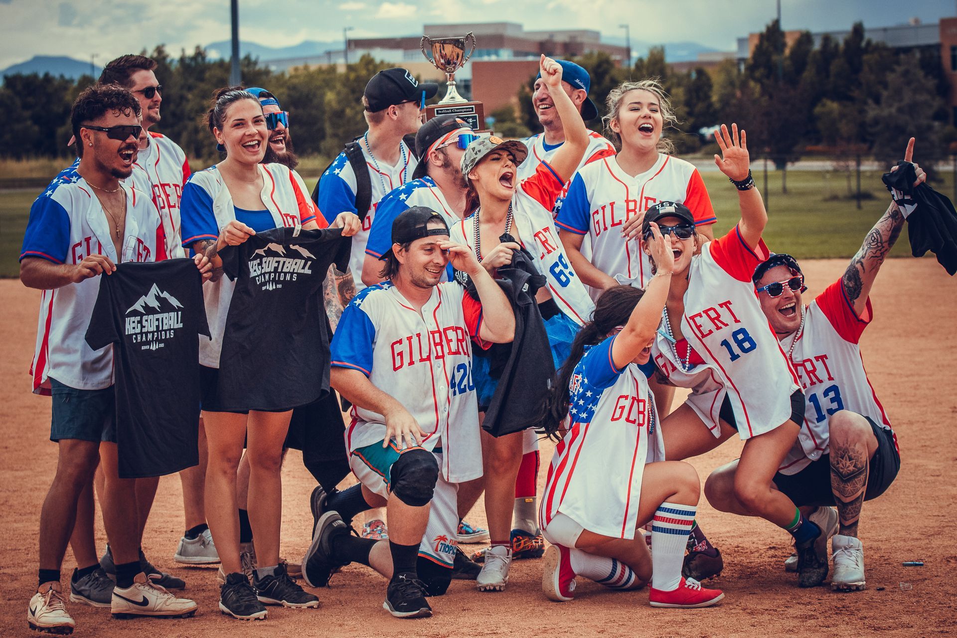 Co-Ed softball team celebrates their tournament championship with a trophy.