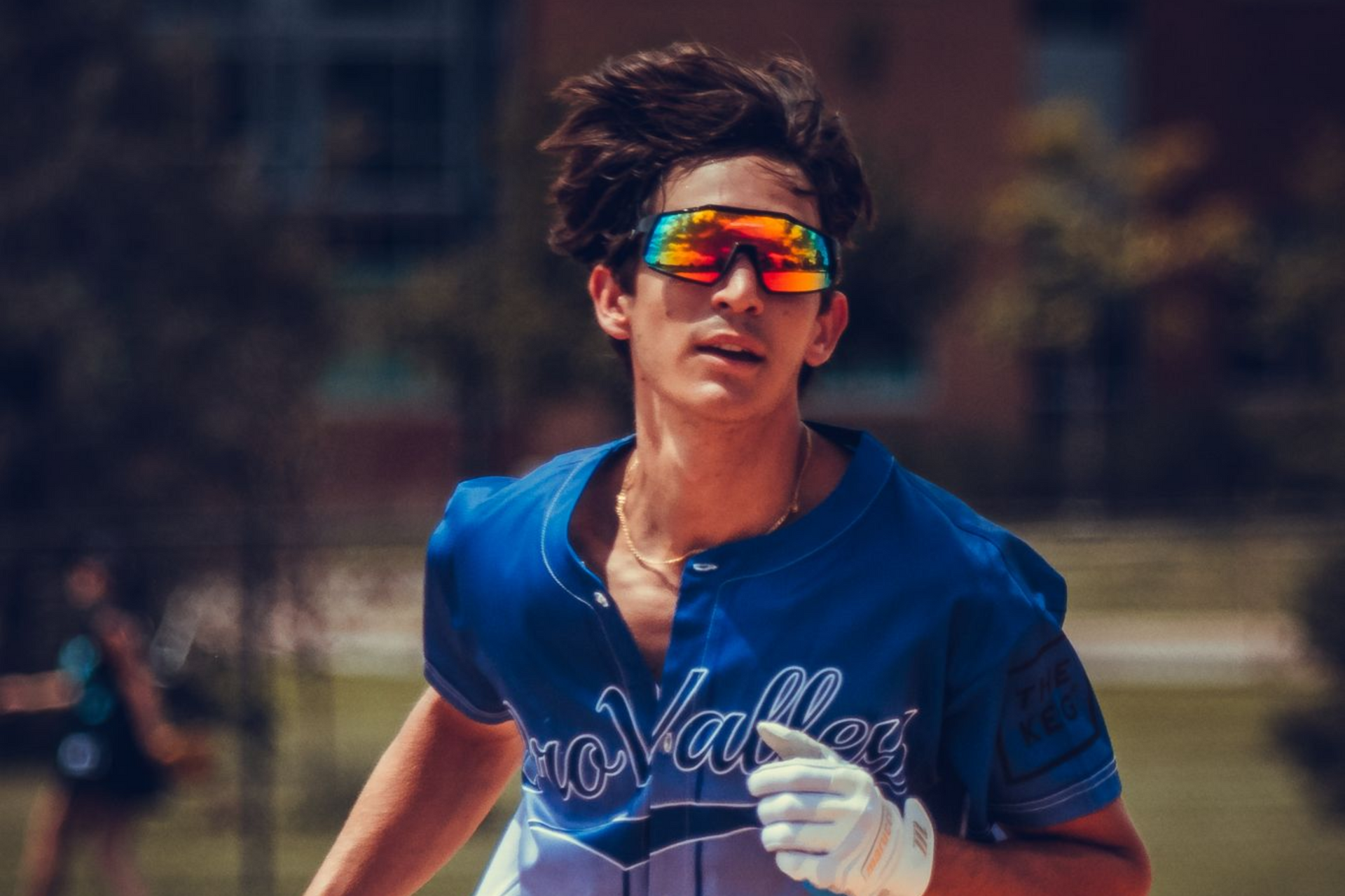 Male softball player running around the bases.