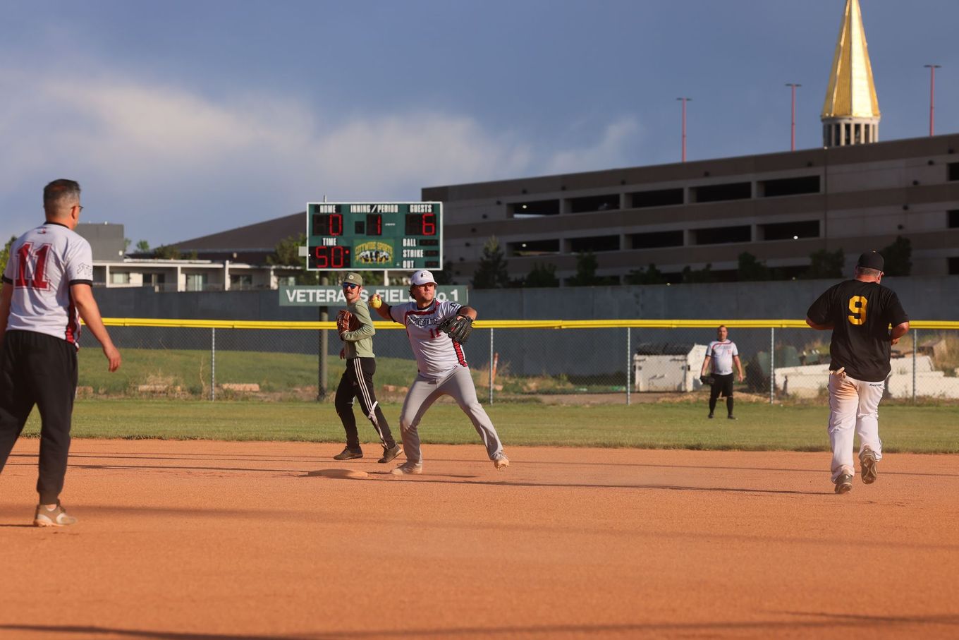 Men playing slow pitch softball.