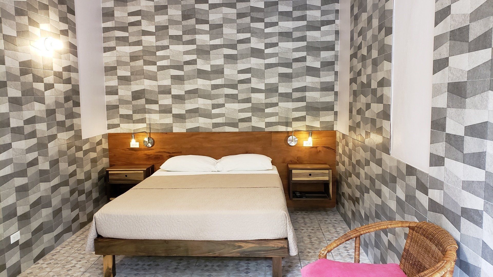 A bedroom with a bed and a chair in it