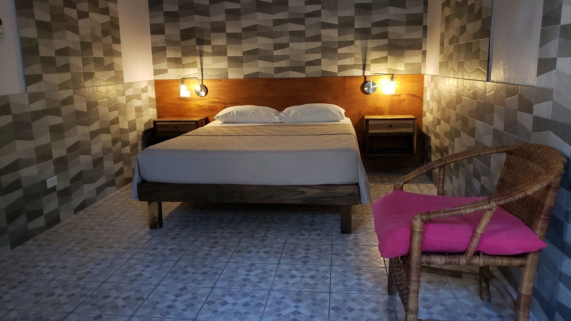 A bedroom with a bed and a chair in it