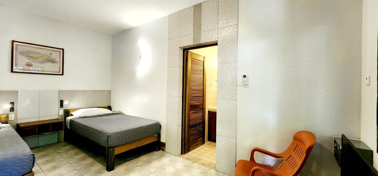 A hotel room with two beds and a chair