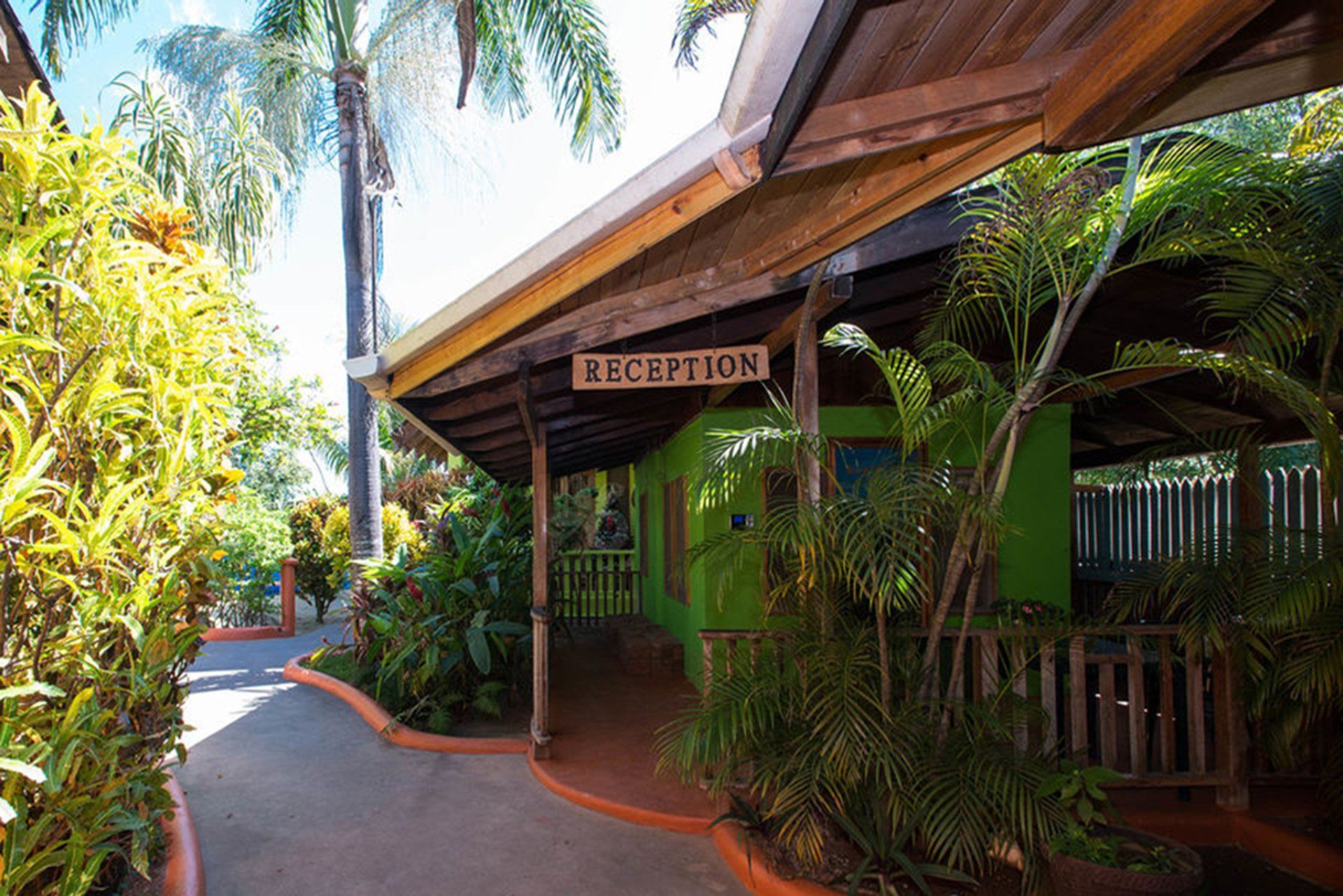 A green building with a sign that says reception on it