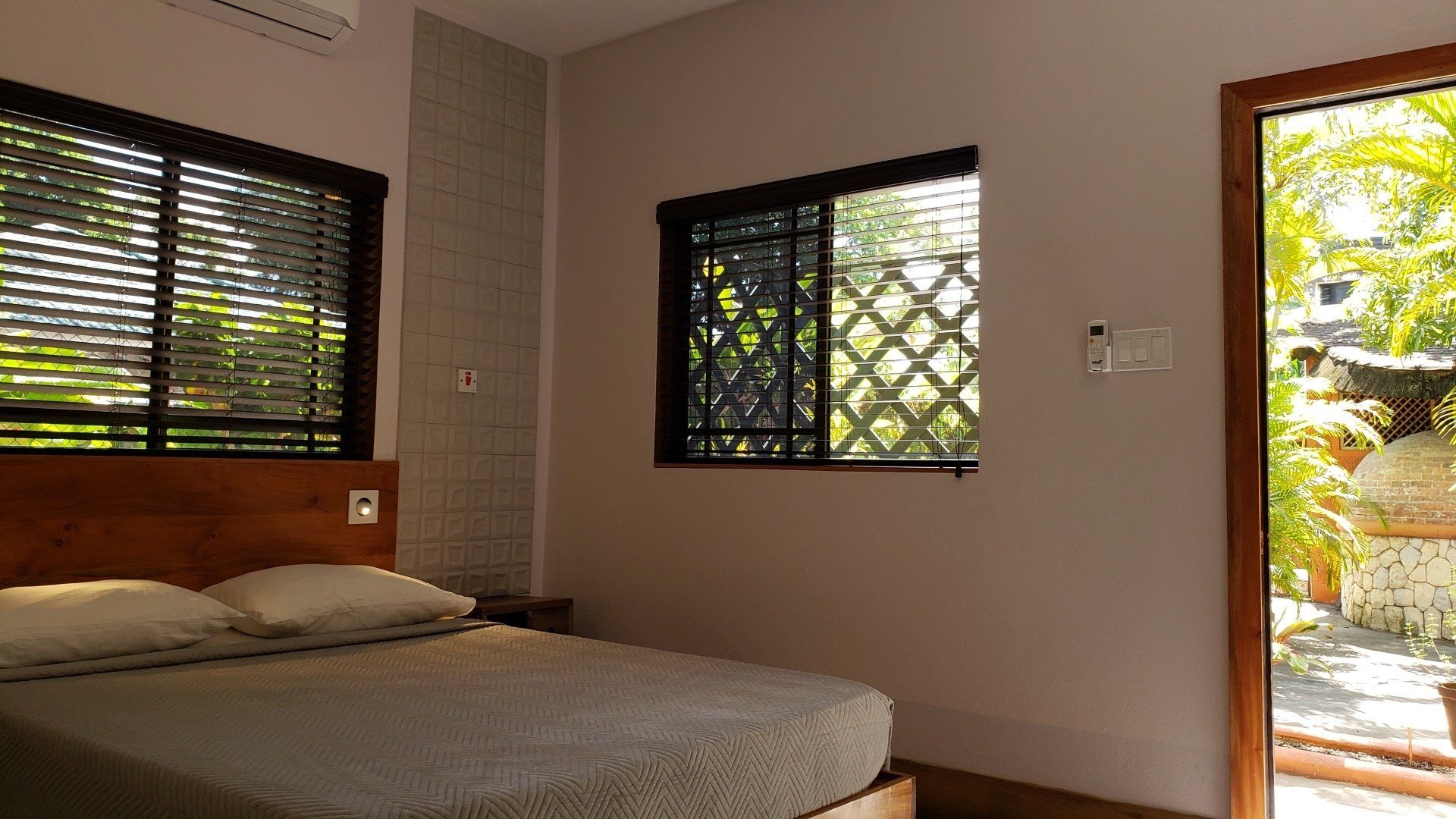 A bedroom with a king size bed and two windows