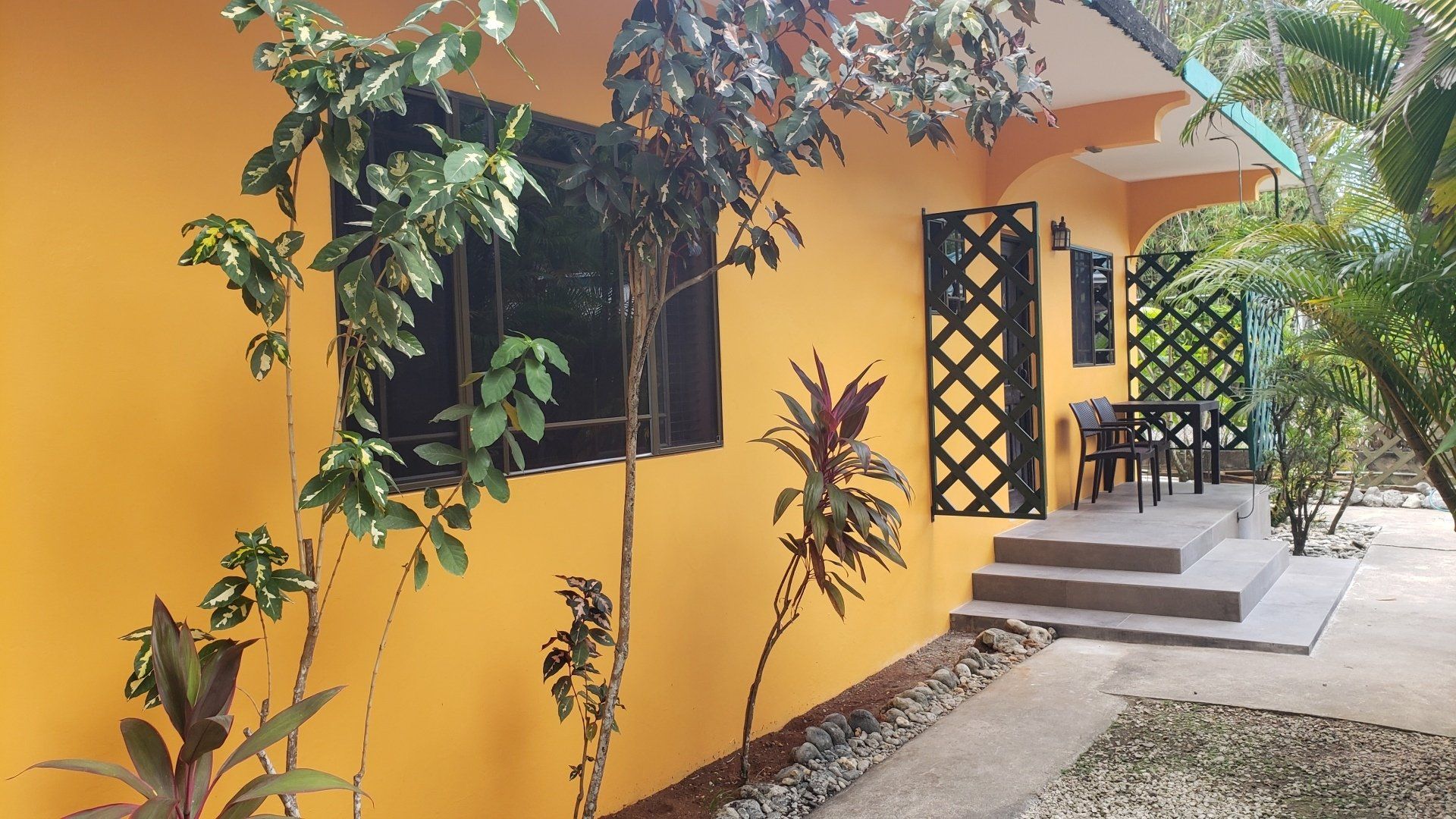 A yellow house with stairs leading up to it