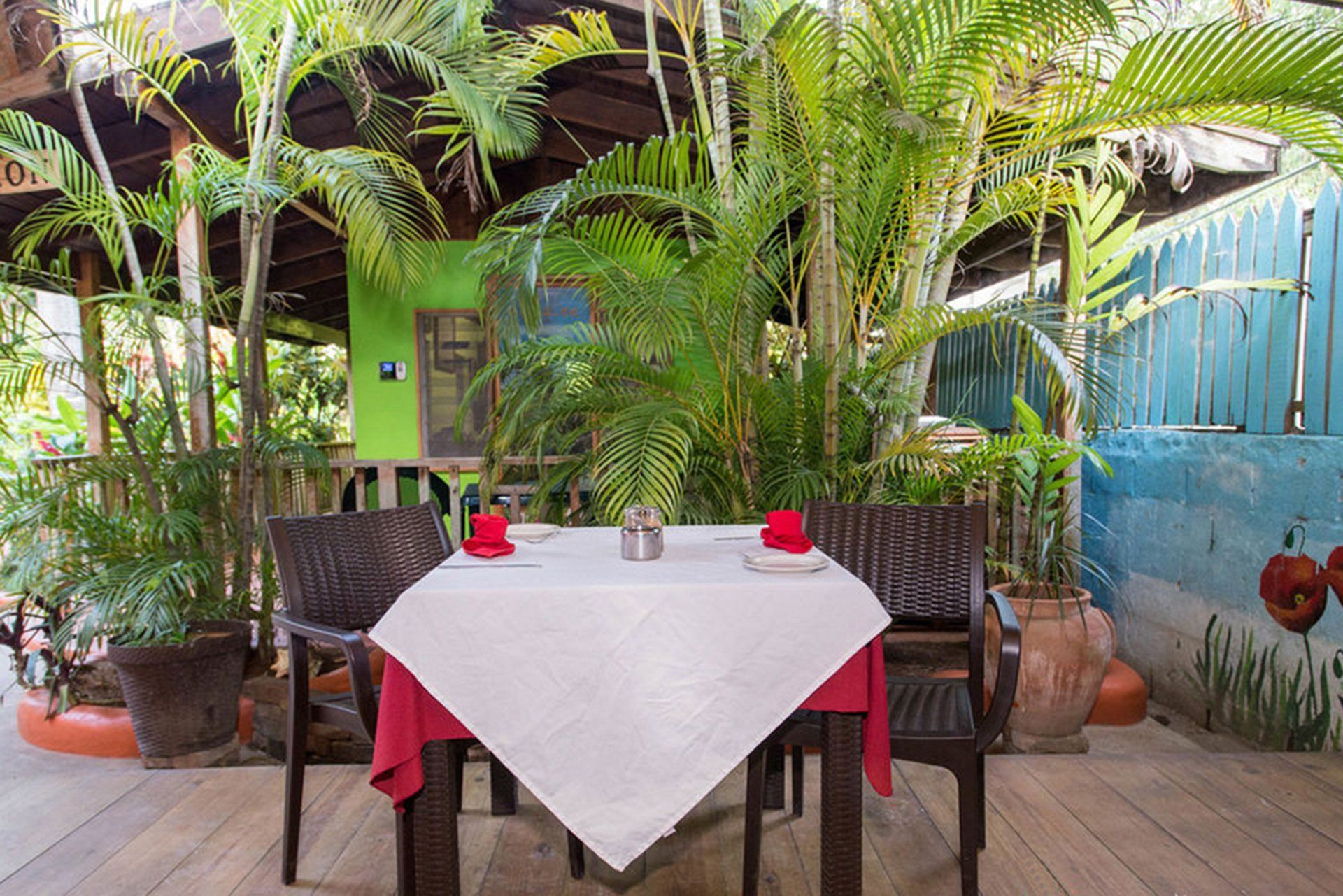 A table and chairs in a restaurant surrounded by trees.