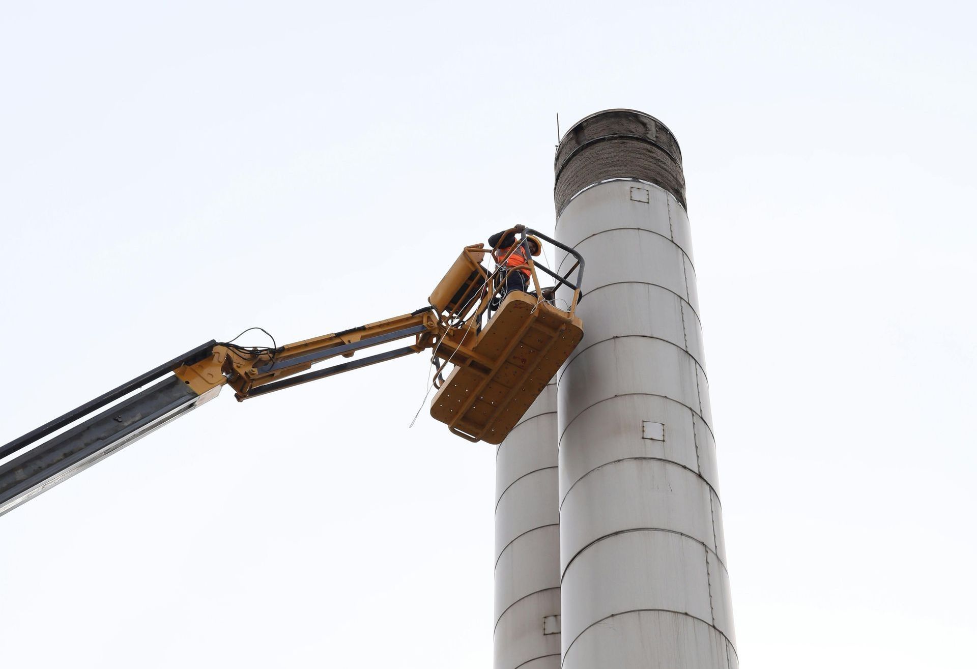 A man is lifting a box in a warehouse.