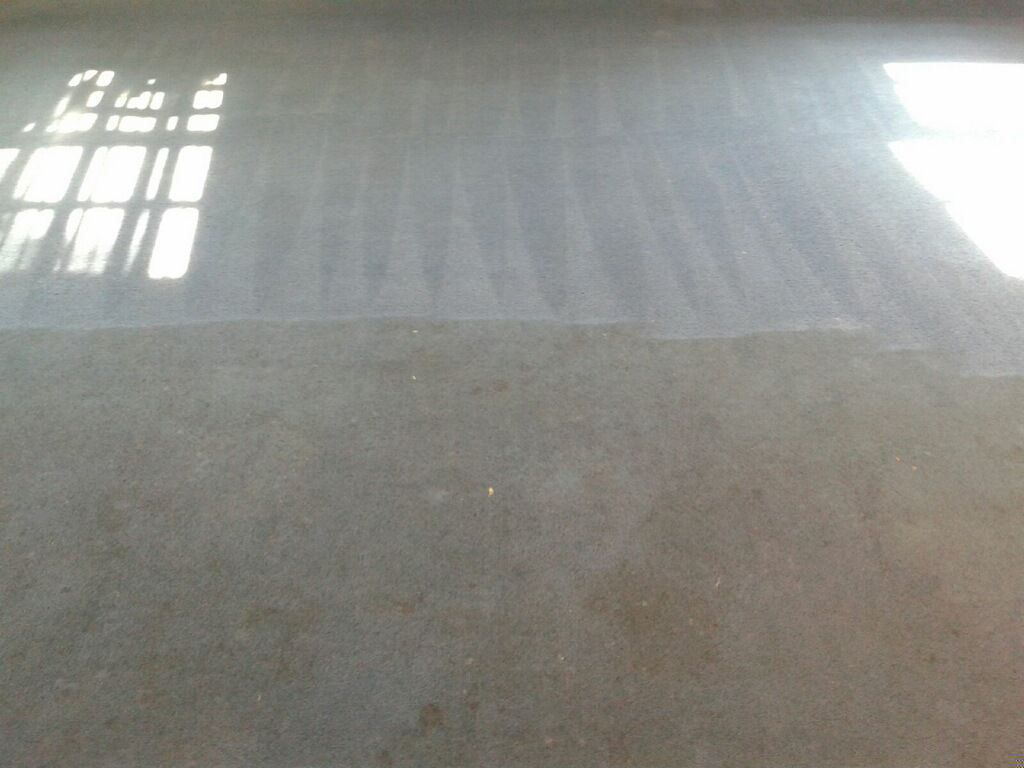 Concrete floor with bright window reflections and sunlight