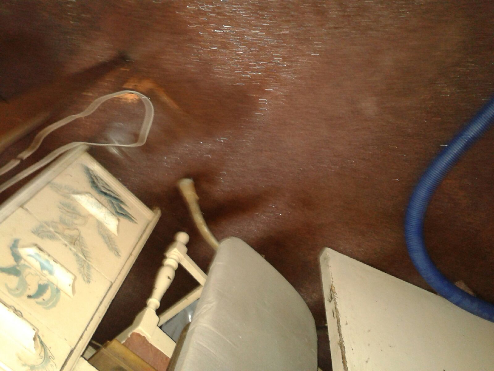 Close-up of a tangled white cable and small electronics on a dark surface.