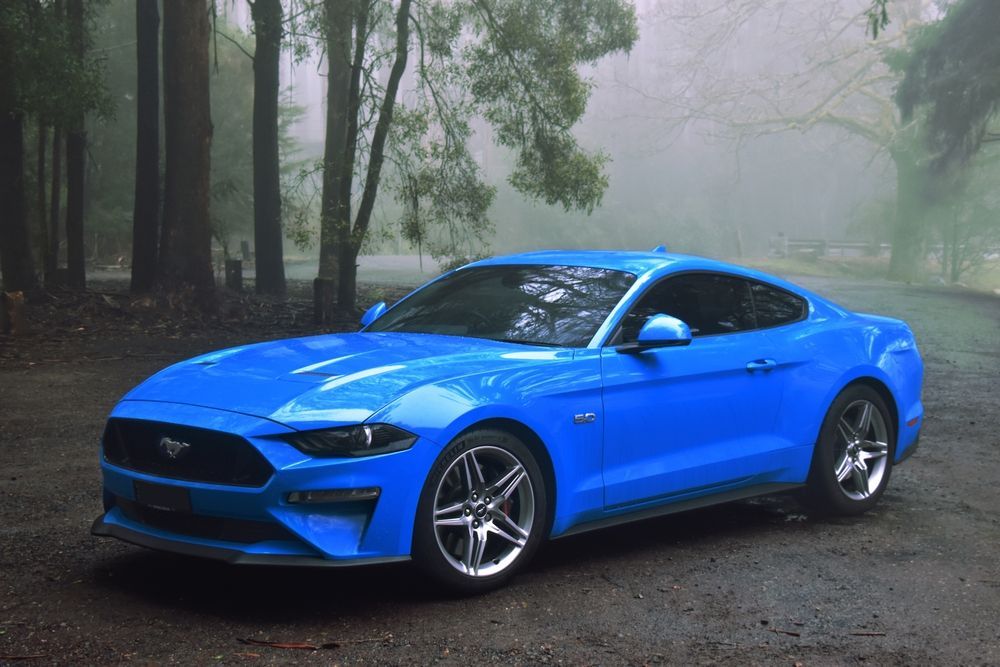 A blue mustang that is someone's project car.