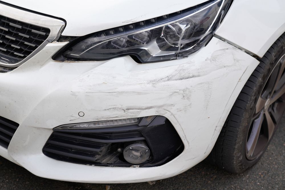 minor car frame damage on a white car