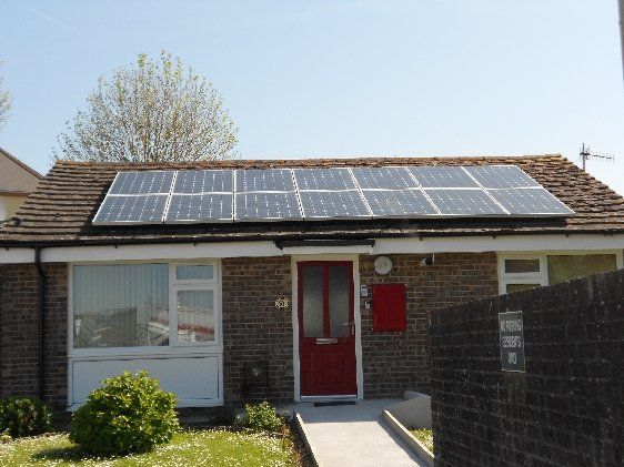 Apollo Electrical Solutions | A brick house with solar panels on the roof