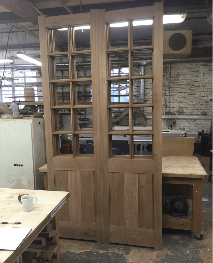 A pair of wooden sliding doors in a workshop