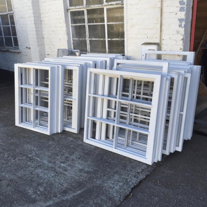 a bunch of white sash windows are stacked on top of each other