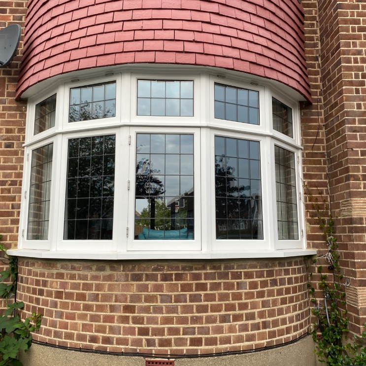 a large timber window on the side of a brick building