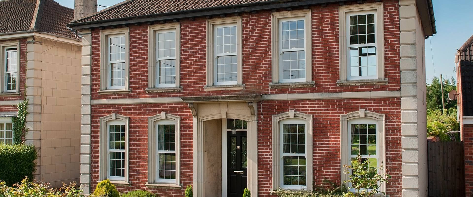 A large red brick house with a lot of windows