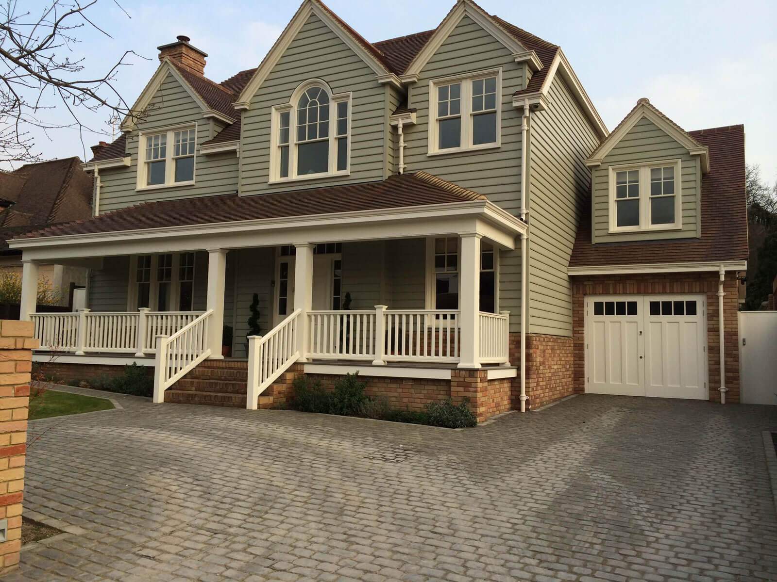 A large house with a large porch and stairs