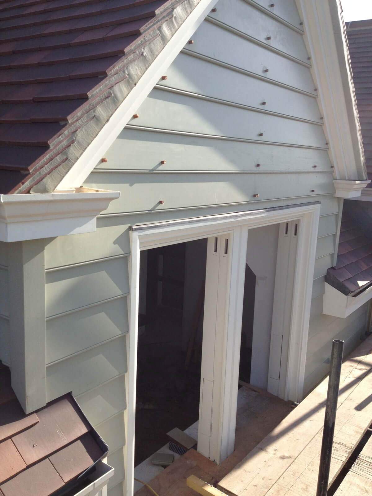 A house with a roof and a door is being built.