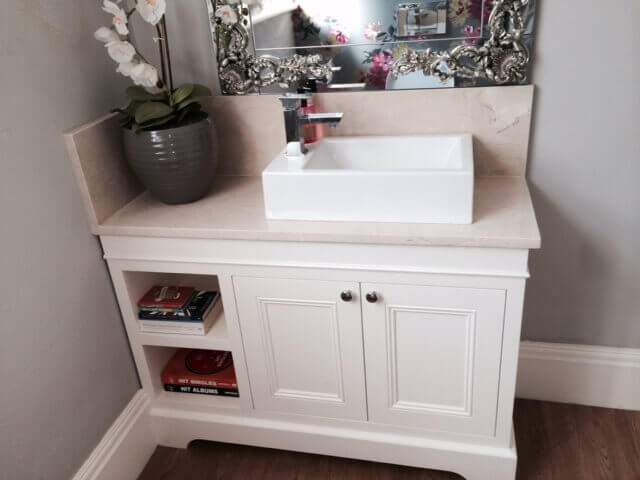 A bathroom vanity with a sink and a mirror