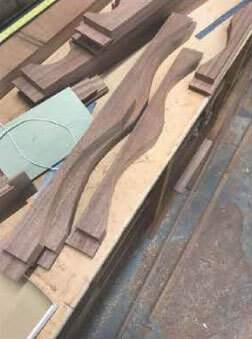 A bunch of wood pieces are sitting on top of a wooden table.