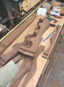 A large piece of wood is sitting on top of a wooden table.