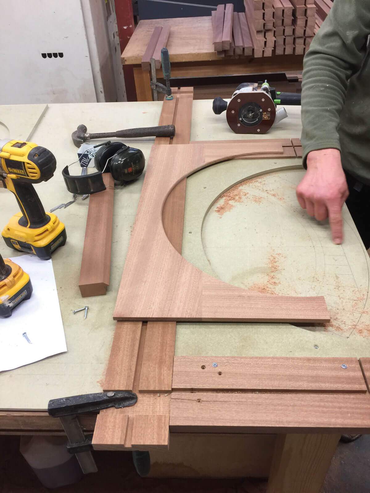 A person is working on a piece of wood on a table