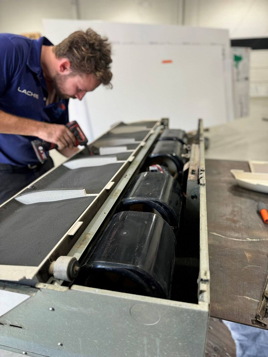 A Man In A Blue Shirt Is Working On A Machine — COOLIT NT In Berrimah, NT