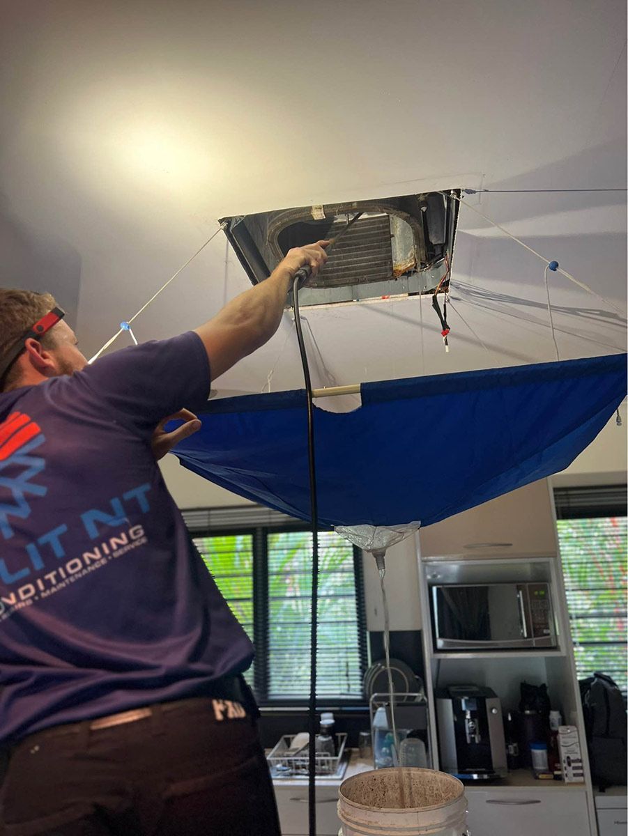 A Man Is Working On A Ceiling AC Outlet In A Kitchen — COOLIT NT In Berrimah, NT