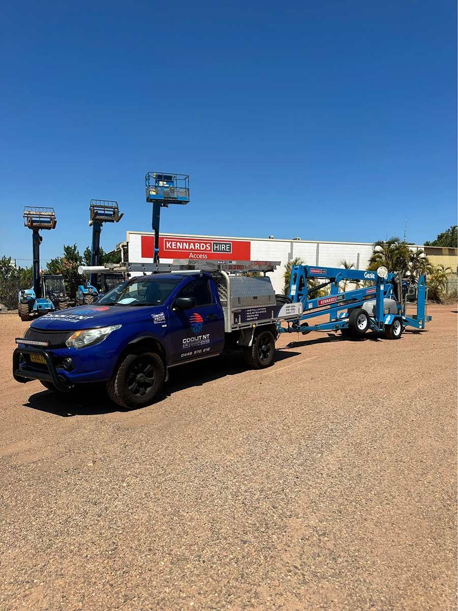 A Blue Truck Is Towing A Crane On A Trailer — COOLIT NT In Berrimah, NT