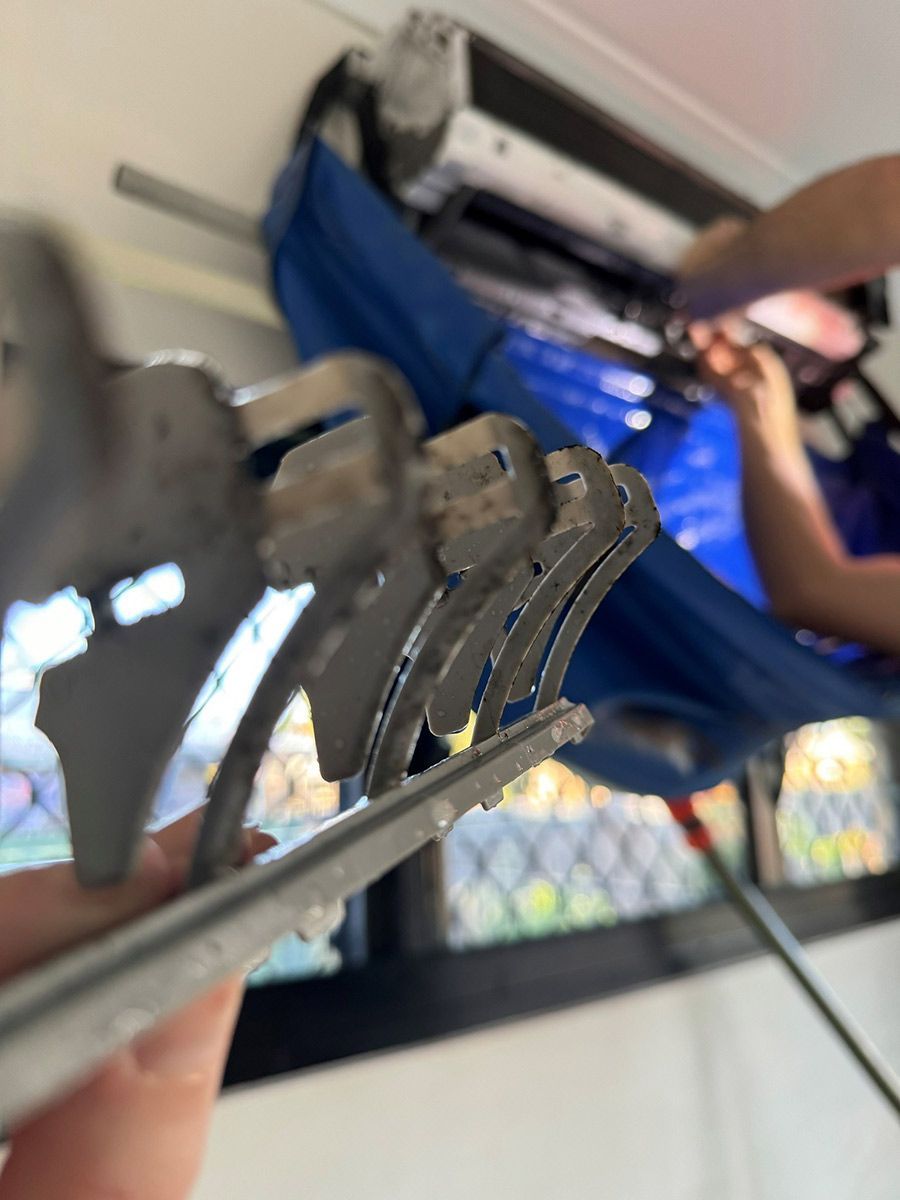 A Close Up Of A Person Holding A Pair Of Scissors — COOLIT NT In Berrimah, NT
