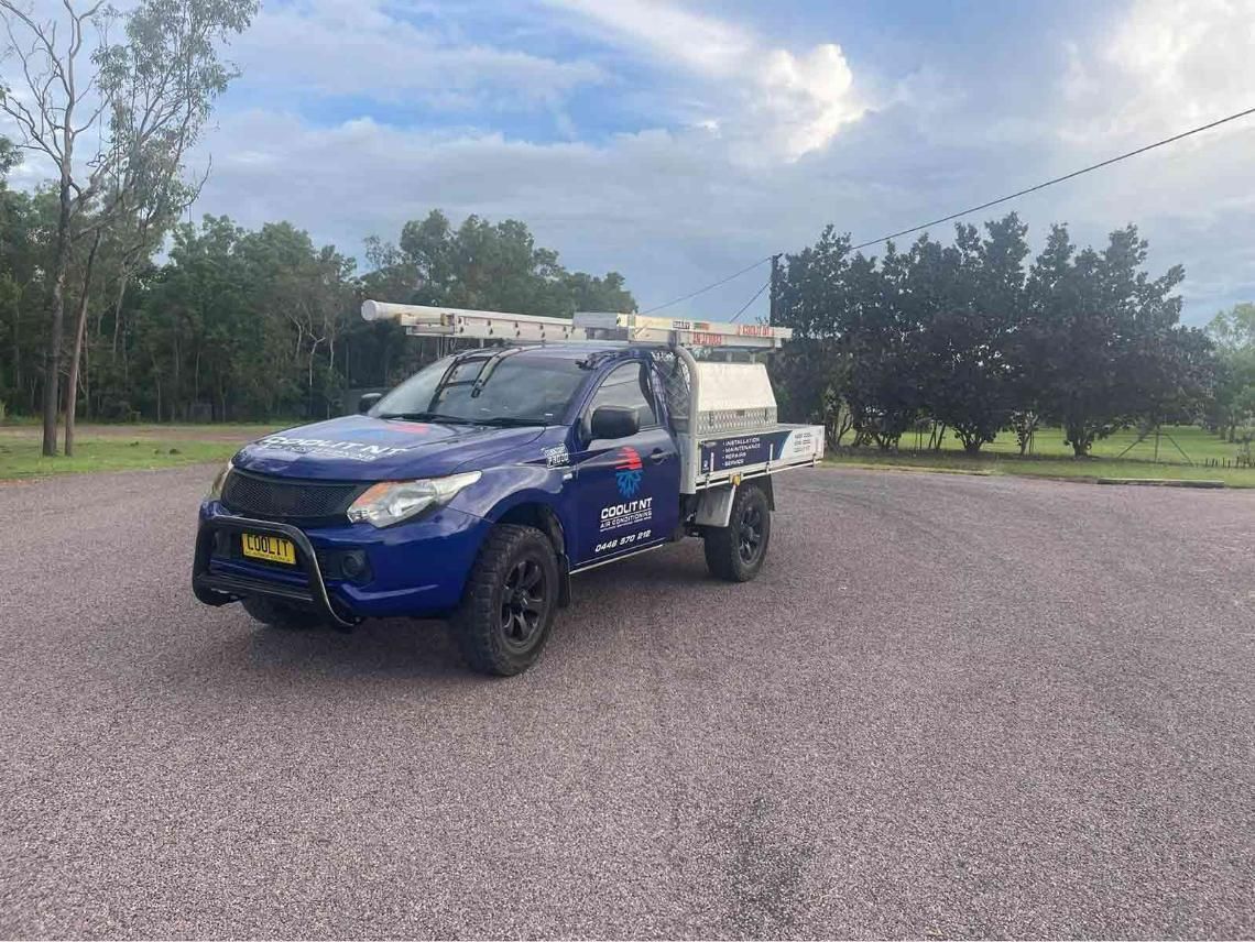A Blue Truck Is Parked In A Gravel Lot — COOLIT NT In Berrimah, NT
