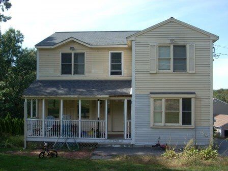 Yellow Siding House- Customized Decks in Leominster, MA
