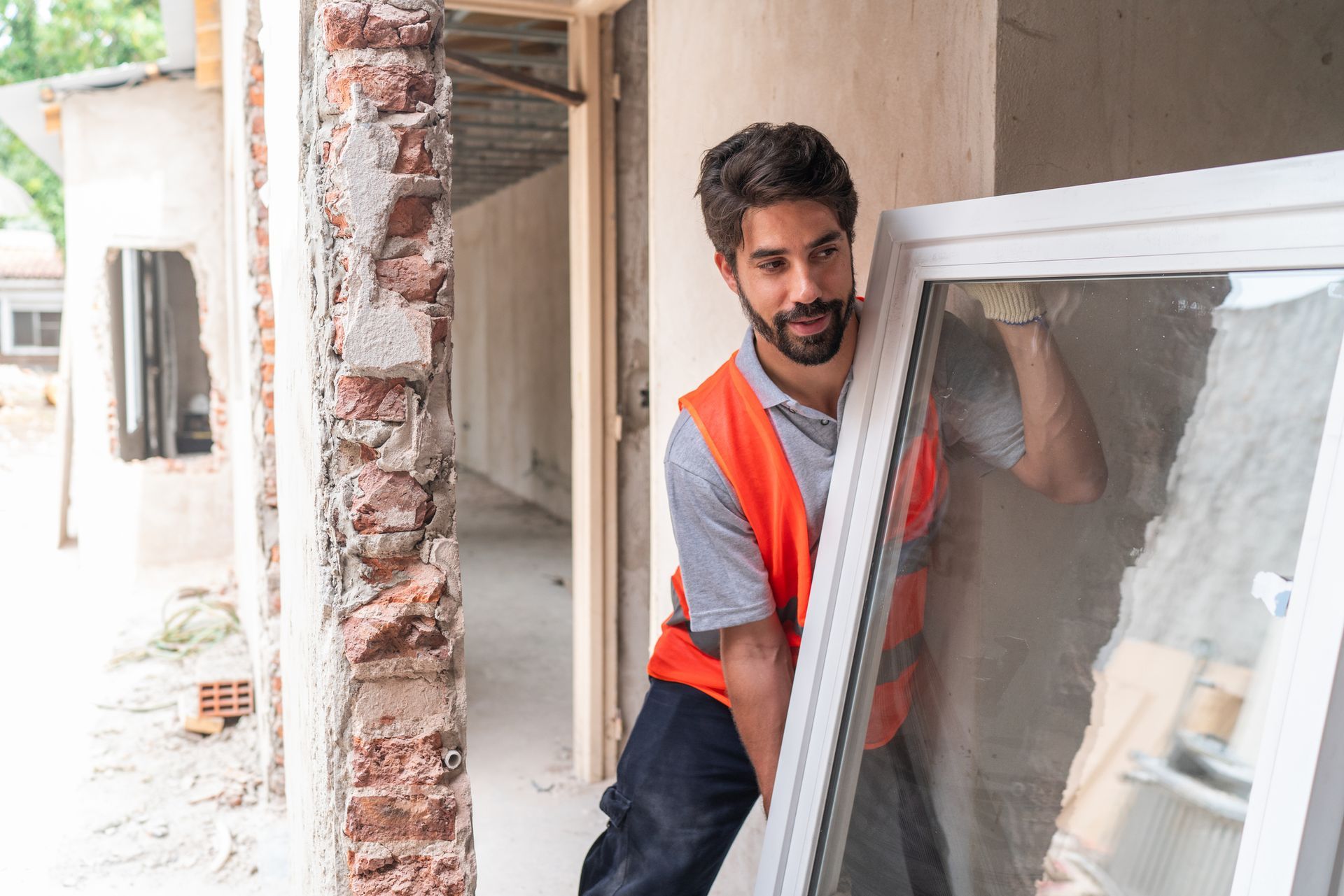 A construction worker doing a window replacement