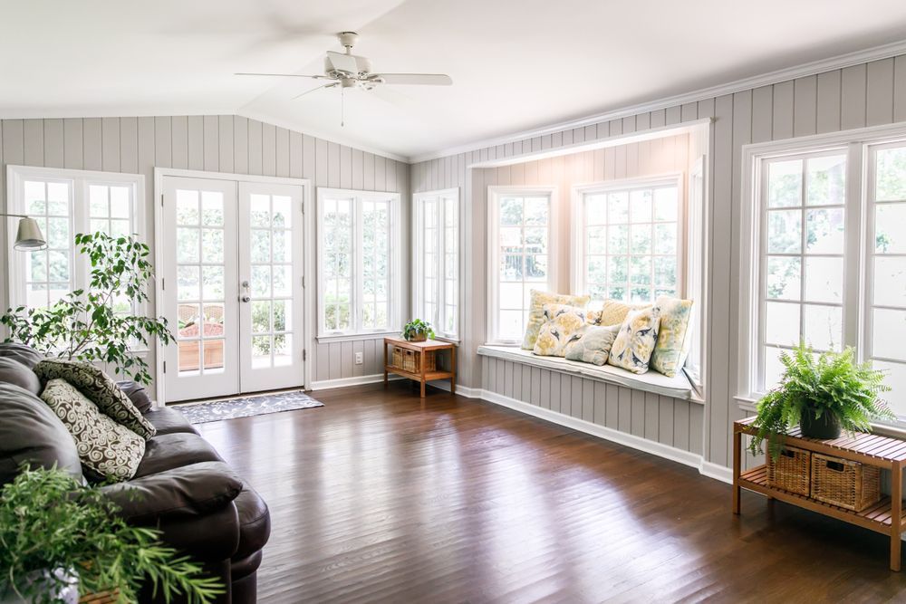 A living room with a couch and a window seat.