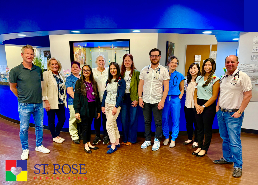 A group of people standing next to each other in a room.