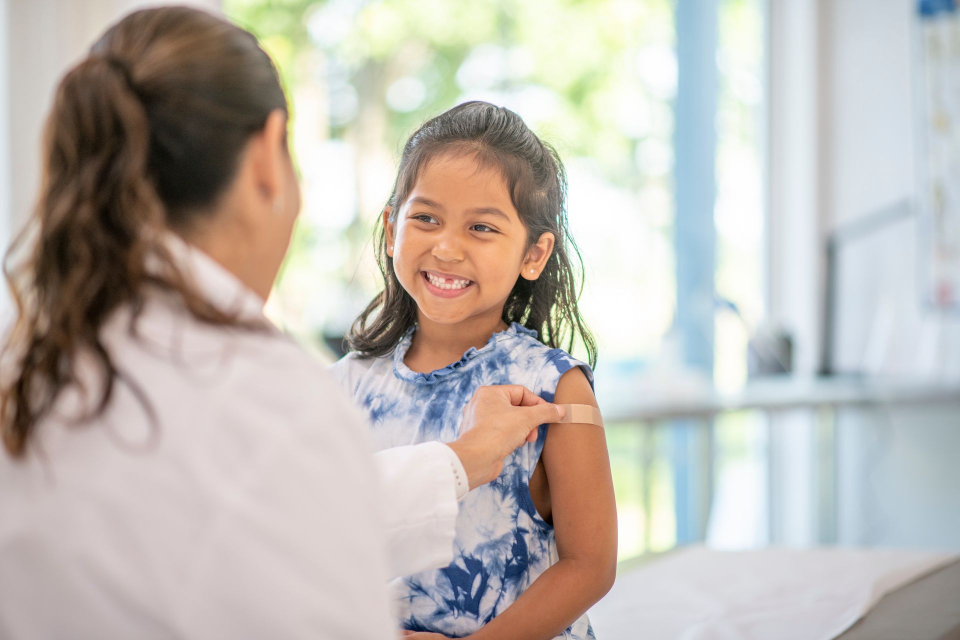 child smiling at a doctor