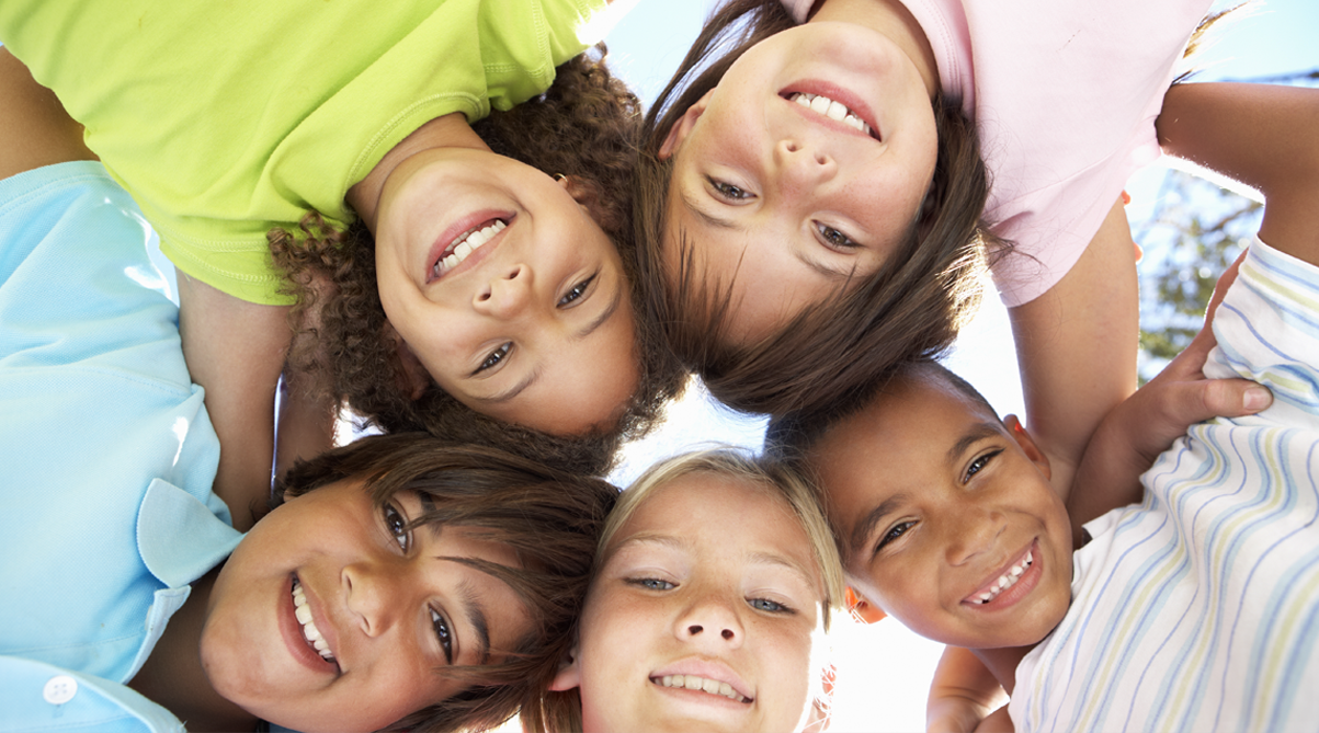 Group of kids looking down in a circle
