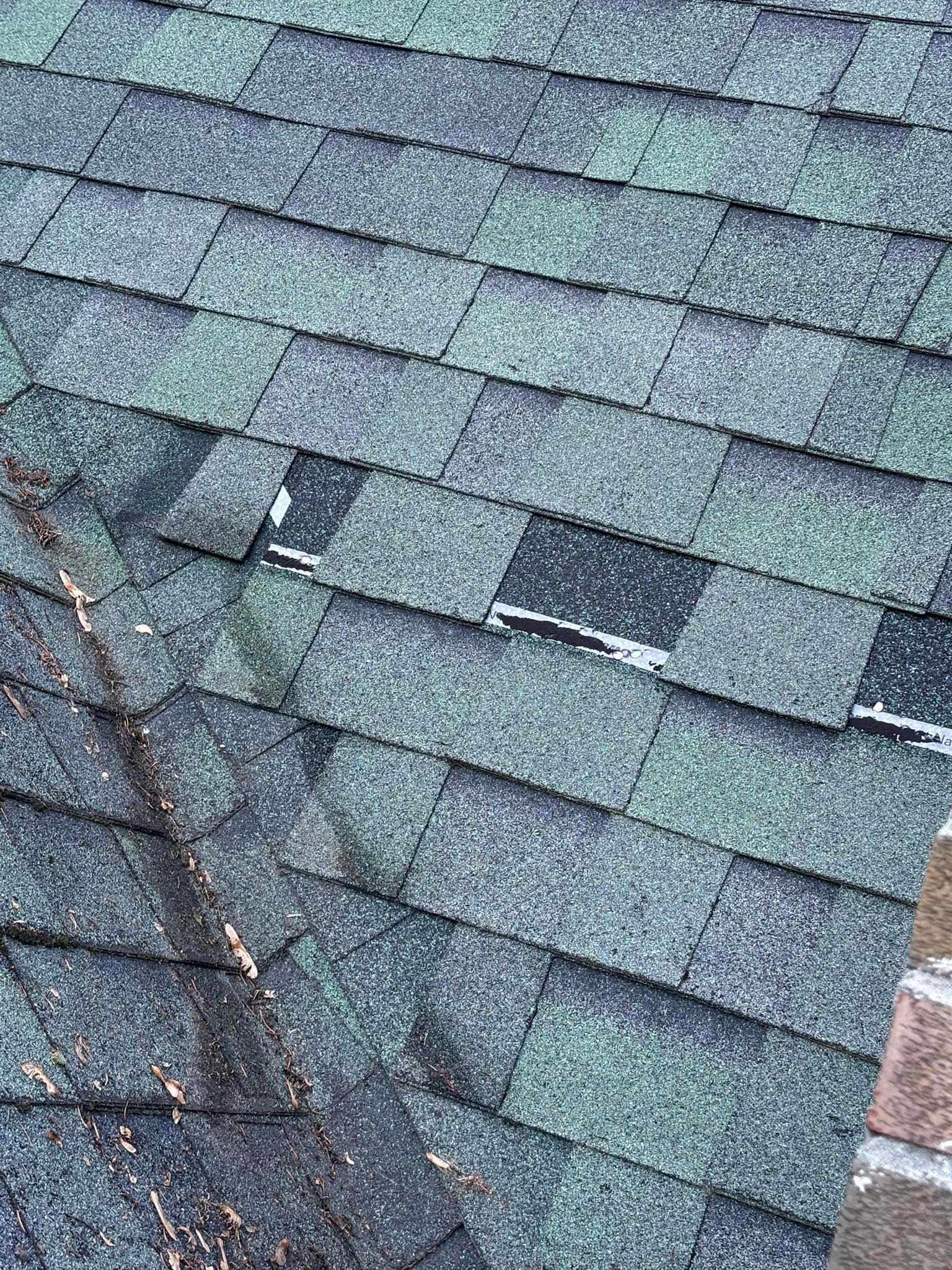 A close up of a roof with shingles that are missing.