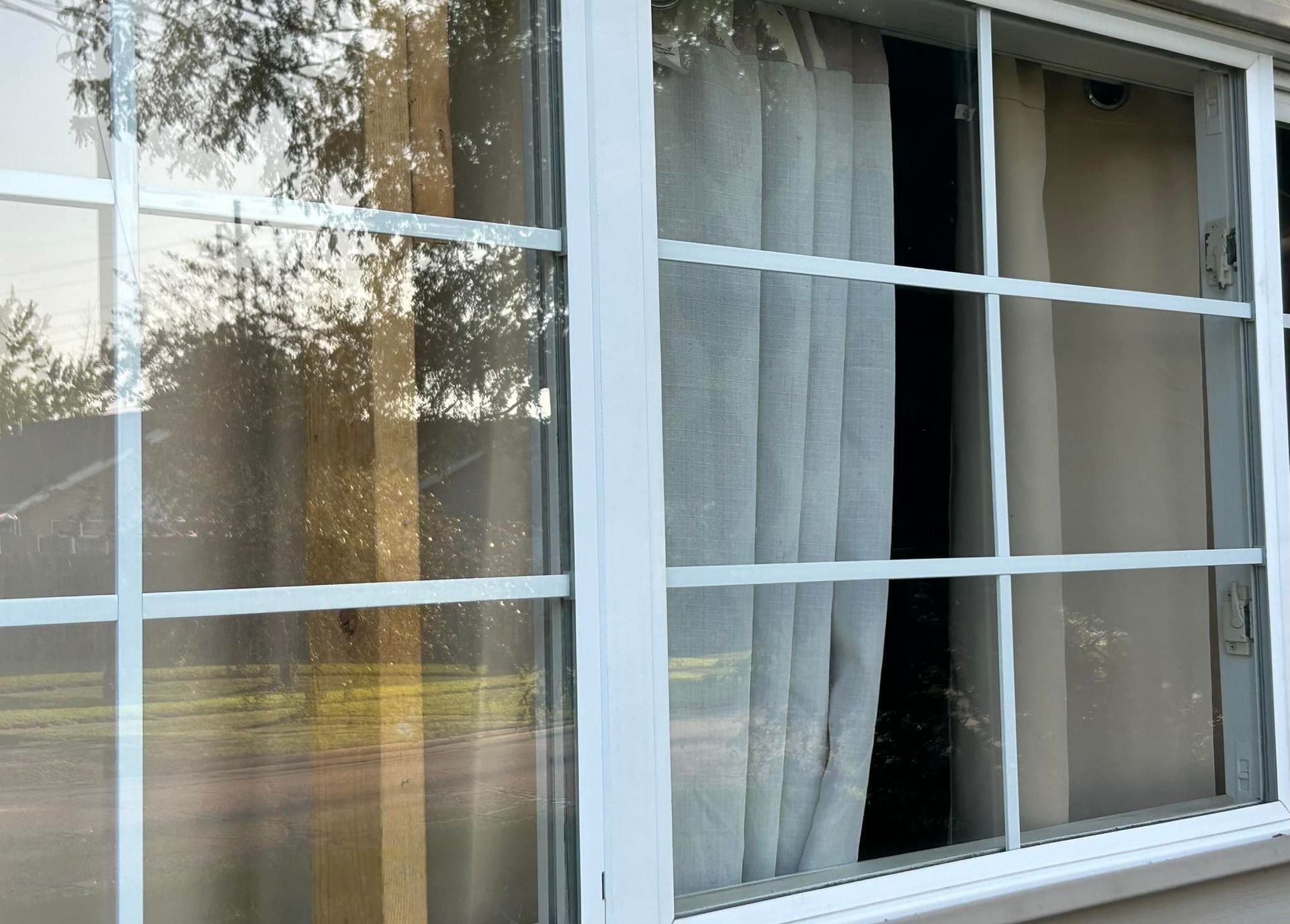 A window with a white frame and curtains on it