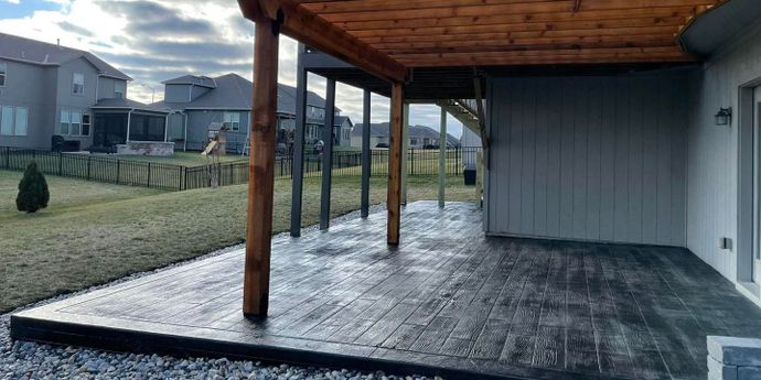 stained and stamped concrete patio with pergola