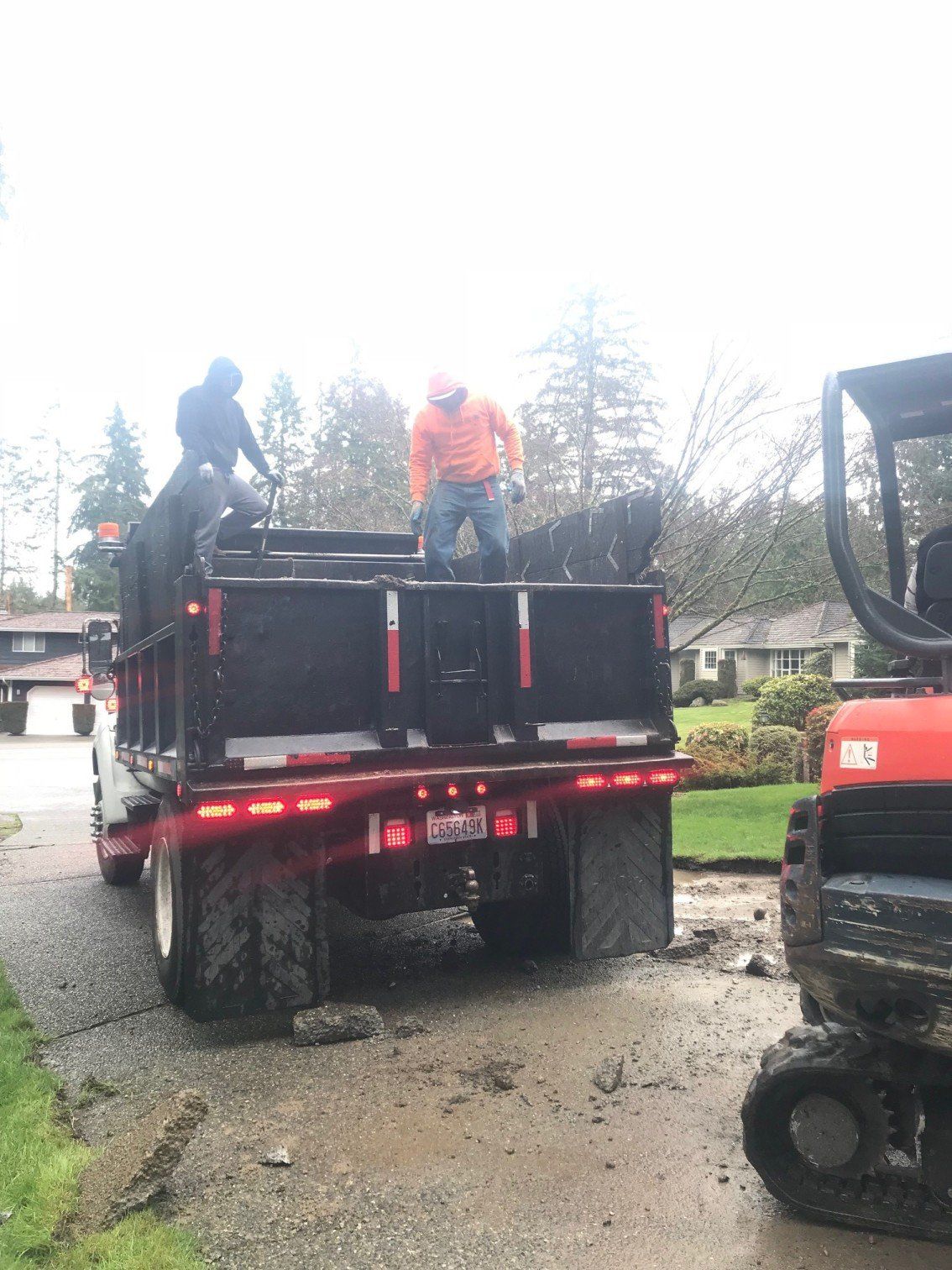 Working Site — Sunrise Landscape Workers Securing Hauling In Everett, WA
